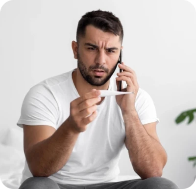 Photo of a man holding a thermometer